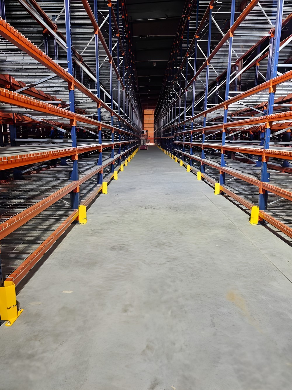Rack aisle with yellow post protectors on every upright